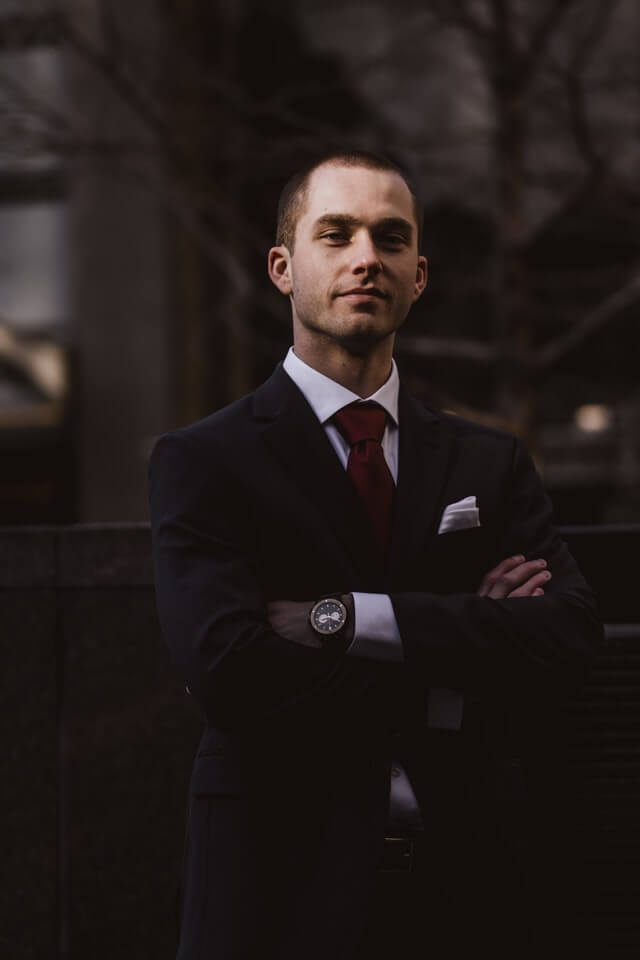 man-wearing-black-notched-lapel-suit-jacket-in-focus.jpg